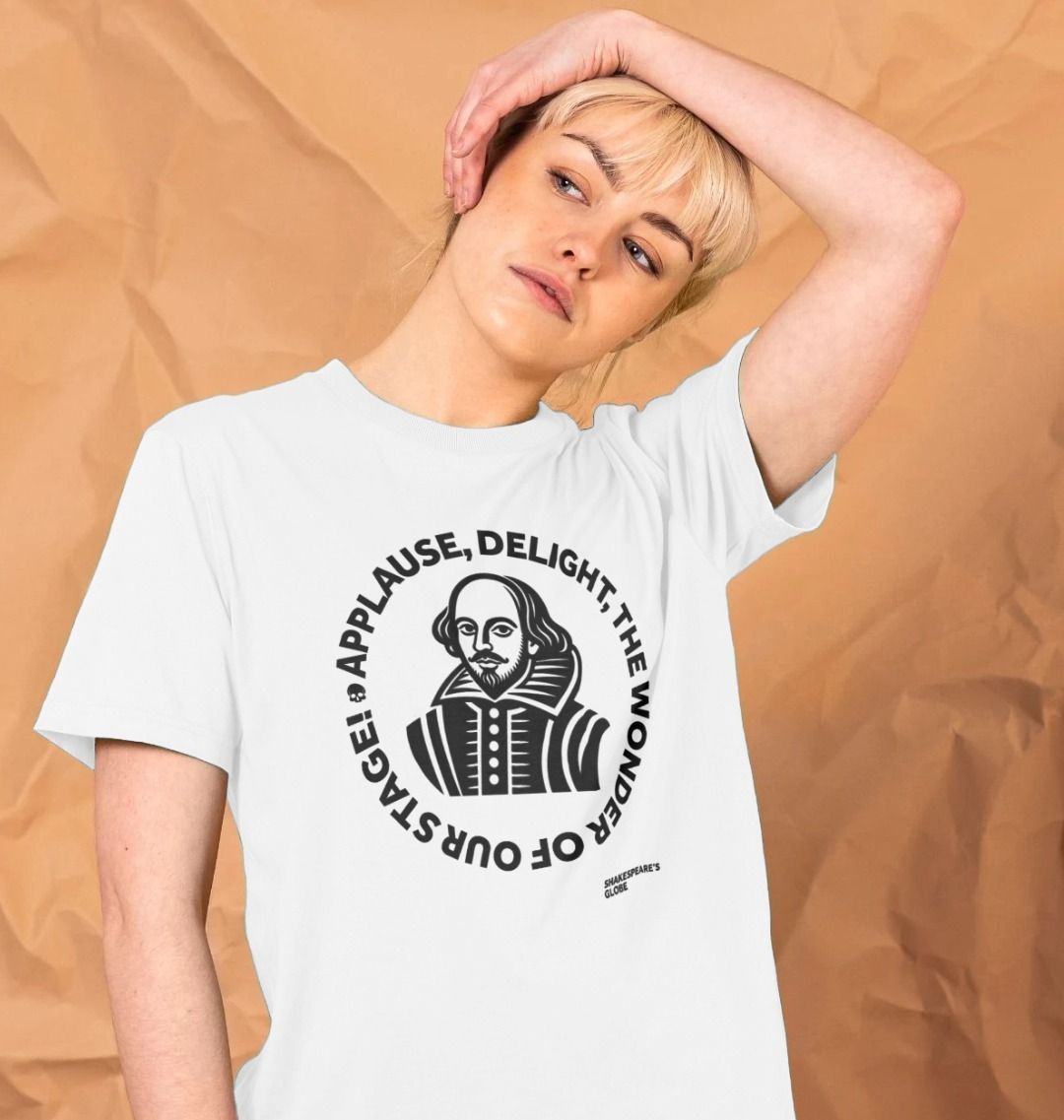 Person wearing a white t-shirt with a graphic design and text on a beige background