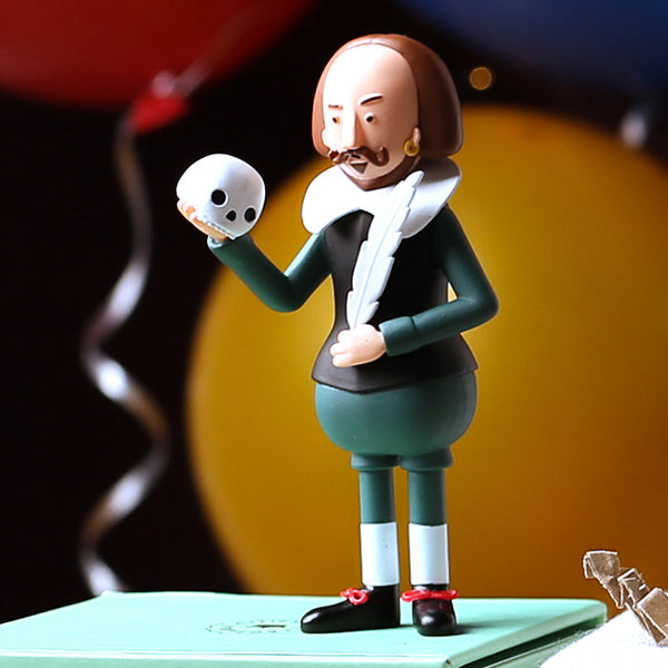 
                  
                    Plastic Shakespeare figurine, holding quill and skull, wearing green outfit, standing on its teal box 
                  
                