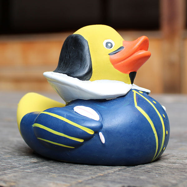 Rubber duck with a blue and yellow design on a wooden surface
