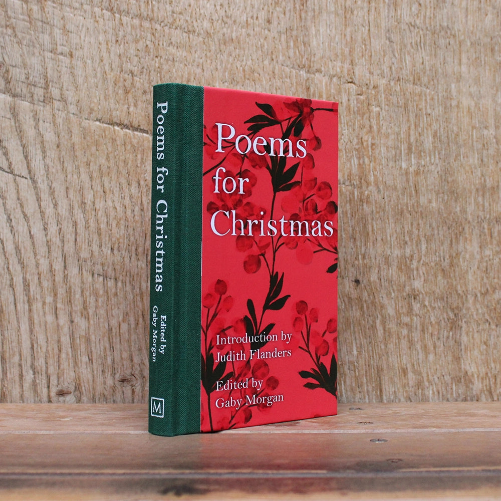 Red hardback book with green spine and white text, featuring red Christmas greenery images