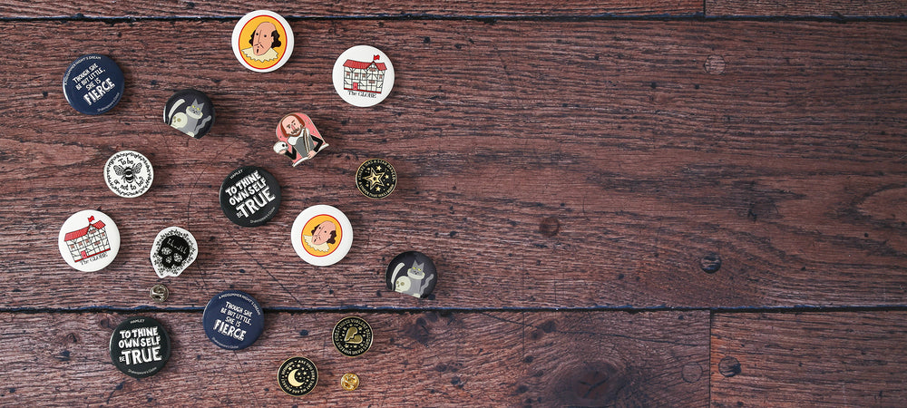 Shakespeare themed button badges and pin badges on wood panel background