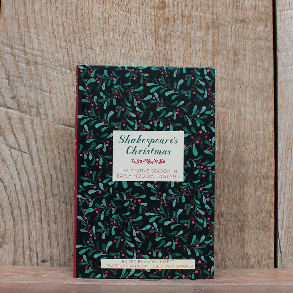 
                  
                    Hardback book with printed festive greenery and berries graphic all over, with white text box and green and red text
                  
                