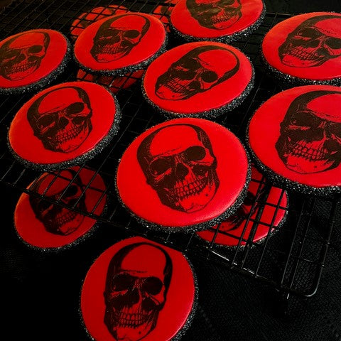 
                      
                        Red circular biscuit with black skull print and black crystal surround
                      
                    