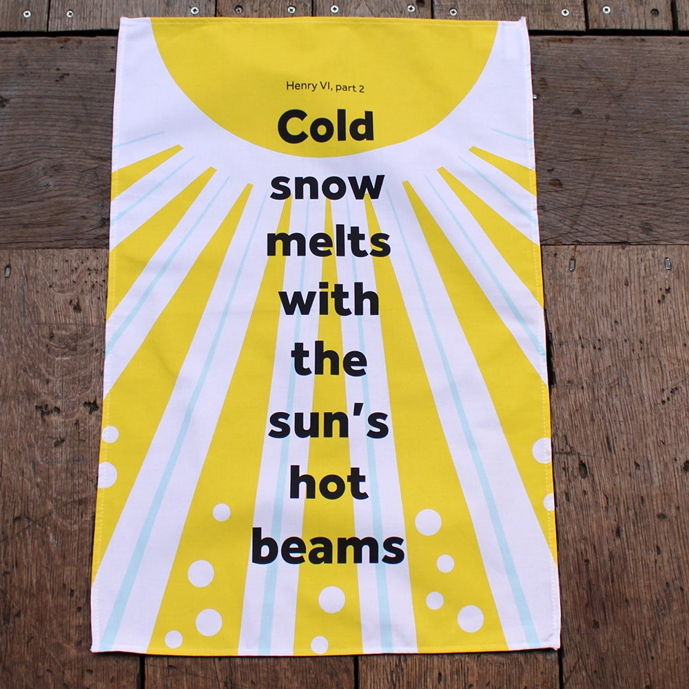 white tea towel with a bright yellow sun print and a quote in black.