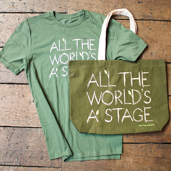Green t-shirt and tote bag with 'All the World's a Stage' text on a wooden surface