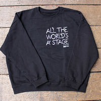 Black sweatshirt with white text on a wooden surface