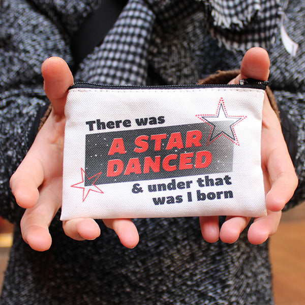 
                  
                    Beige cotton coin purse with top black zipper and red and black 90s graphic text on the front
                  
                