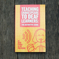 Book cover of 'Teaching Shakespeare to Deaf Learners: The Definitive Guide' on a wooden surface