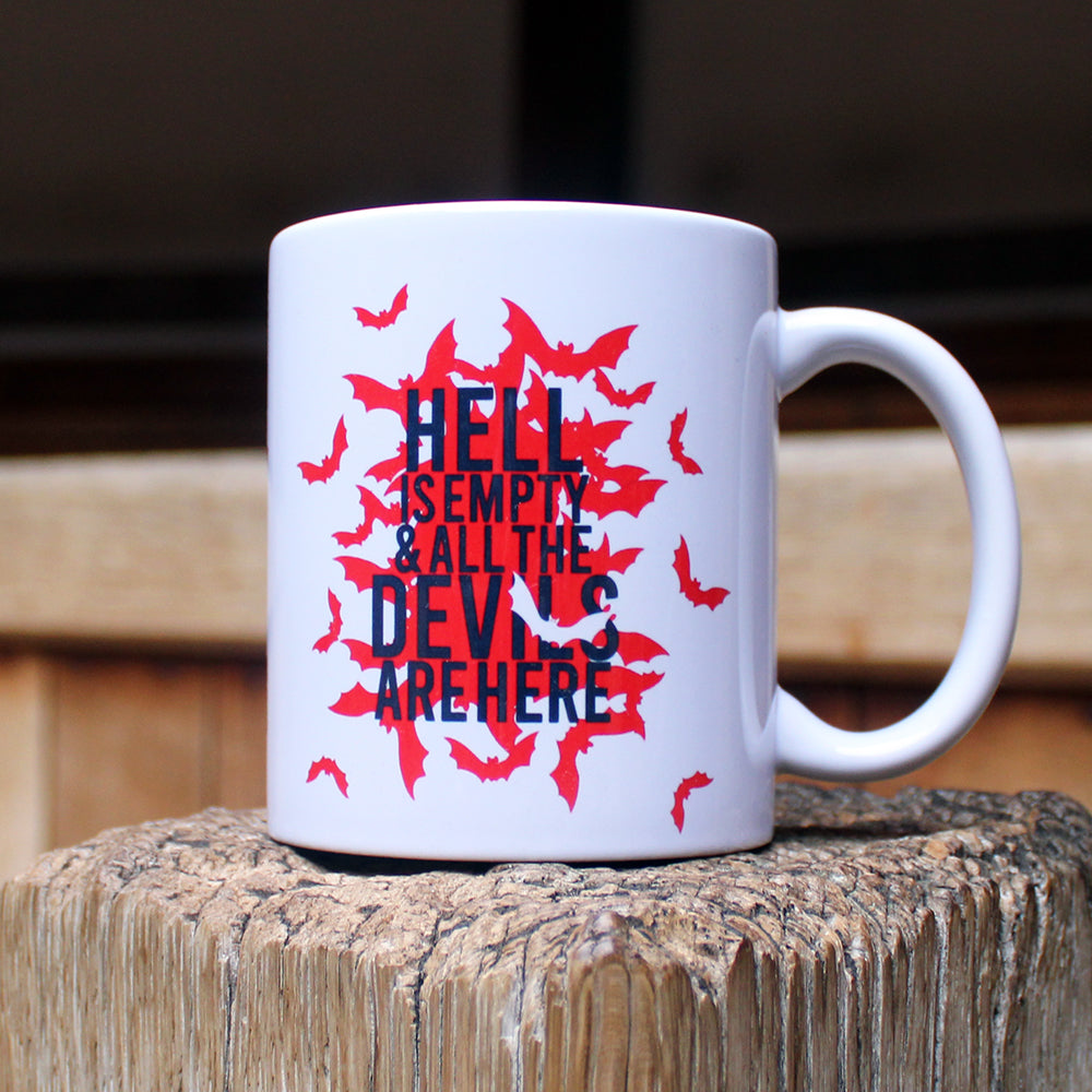 White mug with red bats graphic on either side, with black text overtop