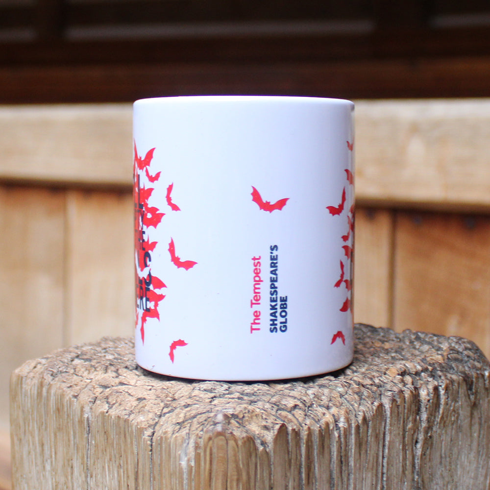 White mug with red bats graphic on either side, with black text overtop