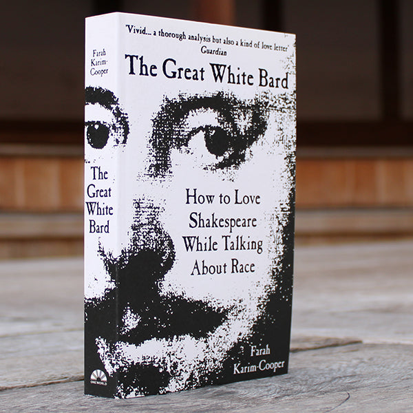 White and black paperback book with obscured image of William Shakespeare's face and black text, book at an angle so spine is visible