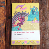 Book cover of 'The Tempest' by William Shakespeare on a wooden surface