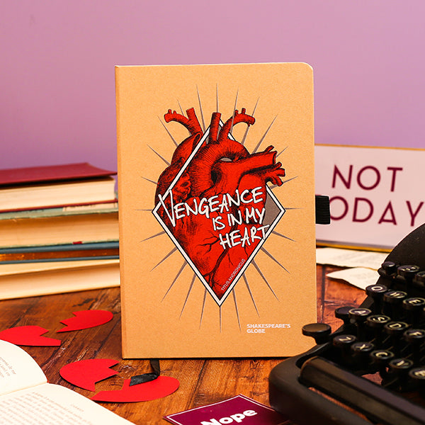 Notebook with heart and text design on a desk with books and typewriter