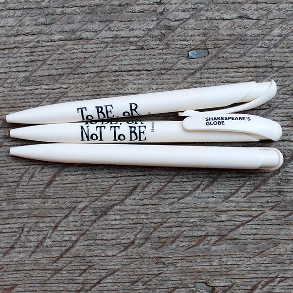 Off white bioplastic pen with black graphic text on wood plank