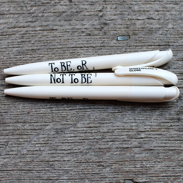 Off white bioplastic pen with black graphic text on wood plank