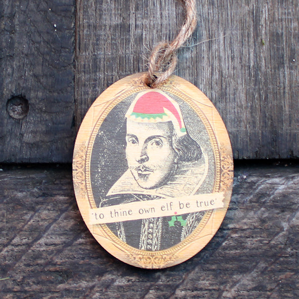 
                  
                    Wooden oval decoration with black portrait and cartoon red santa hat
                  
                