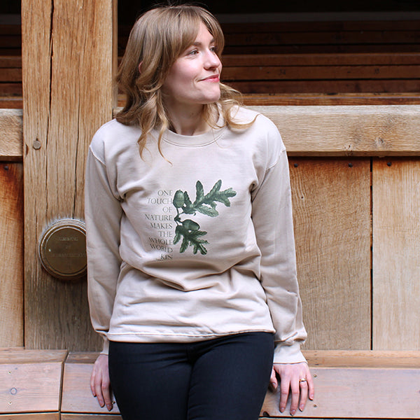 Beige polycotton sweatshirt with central forest green quote and acorn leaf graphic