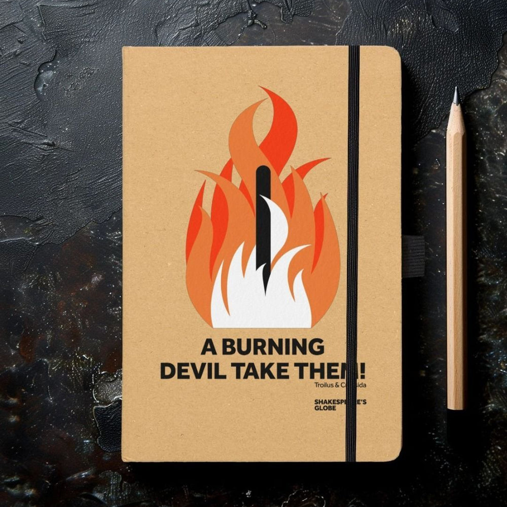 a notebook with a kraft paper cover and a print of a bonfire in orange and  red with a quote in lack beneath.