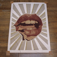 Artistic depiction of lips with geometric patterns on a wooden surface