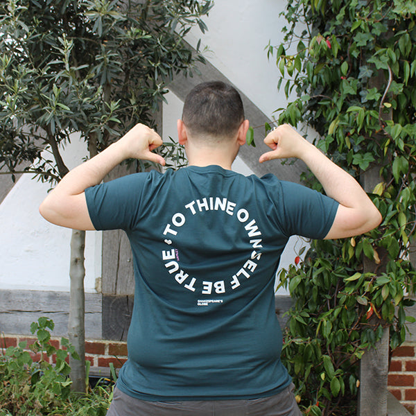 denim blue t-shirt printed on the back with large white text in a circle
