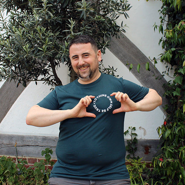 denim blue t-shirt printed on the front with small white text in a circle on left breast