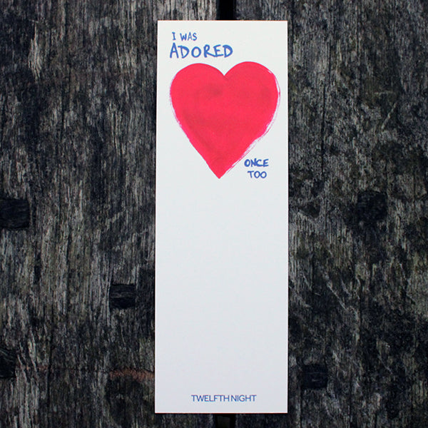 White rectangular bookmark with red painted heart on the top and blue graphic text