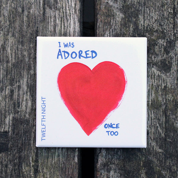 White square magnet with red painted heart in the centre and blue graphic text surrounding