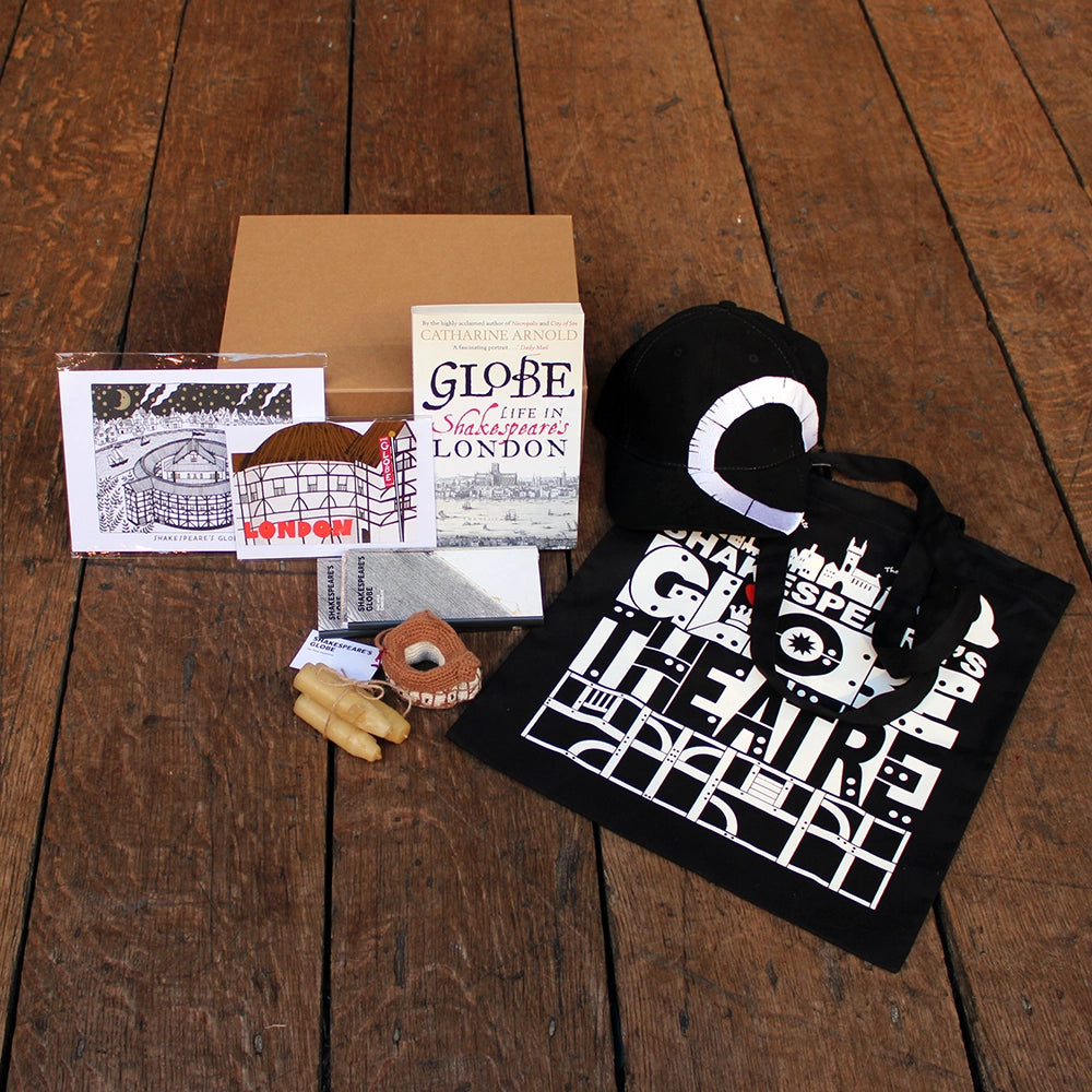 Kraft cardboard box open, displaying a selection of Shakespeare's Globe gifts