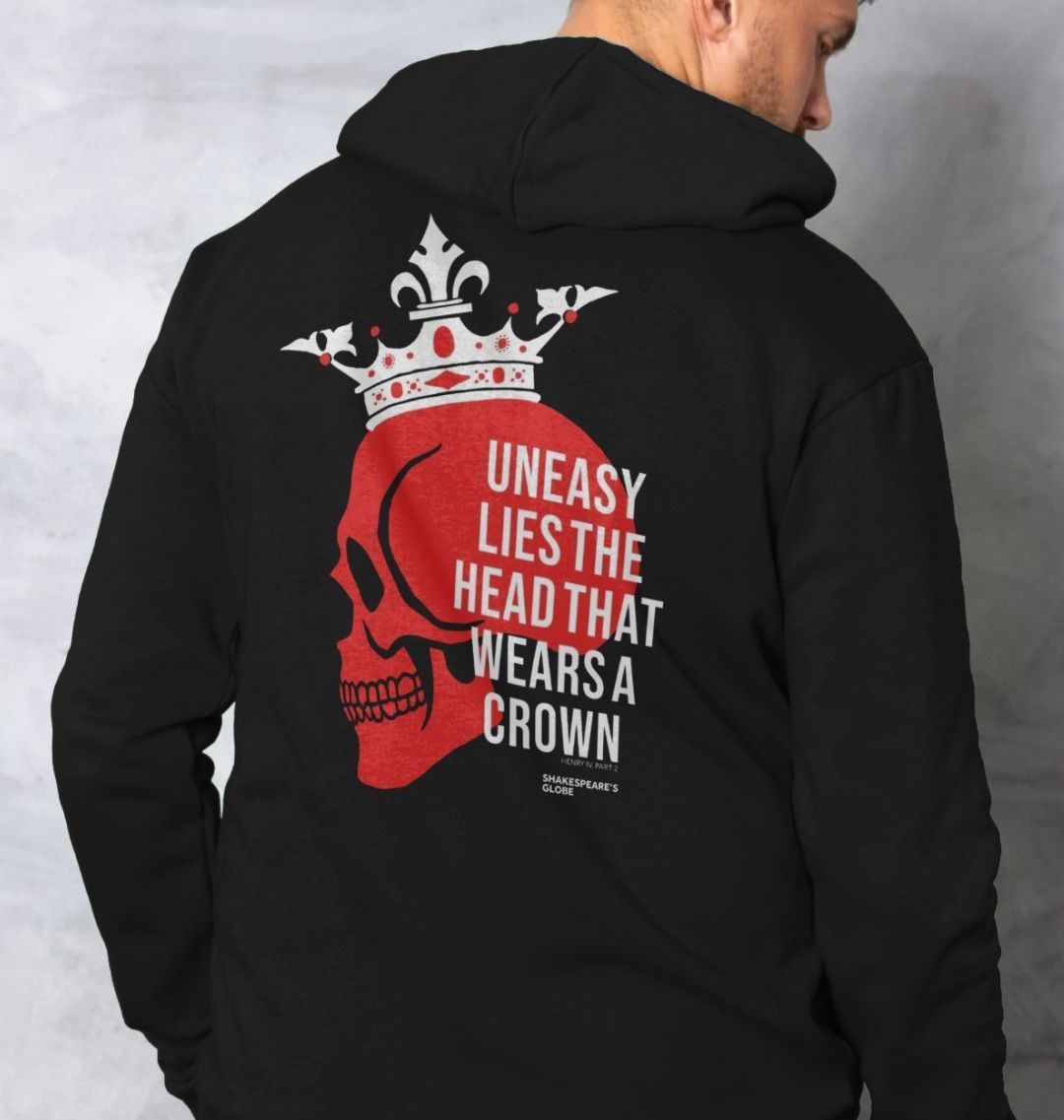 Black hoodie with red and white centred  print featuring a red skull wearing a white crown, overlayed with white text across the back