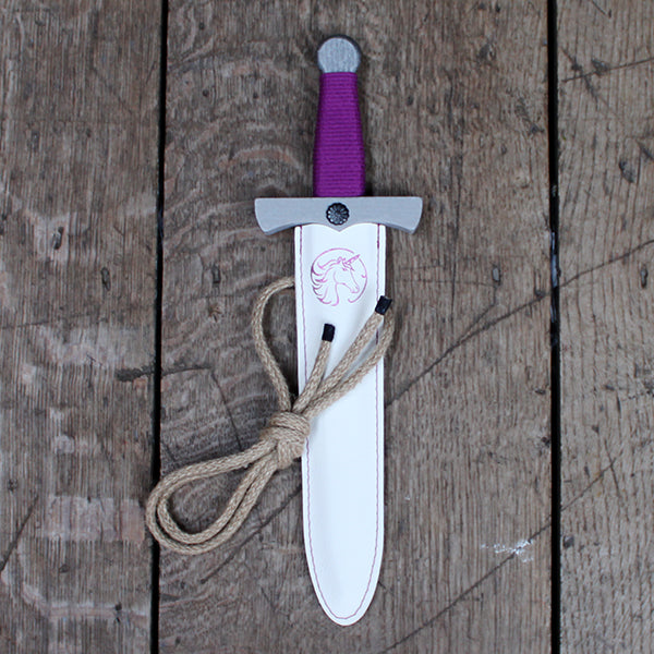 Silver painted wooden dagger with purple wrapped handle and white pleather sheath printed with purple unicorn branding