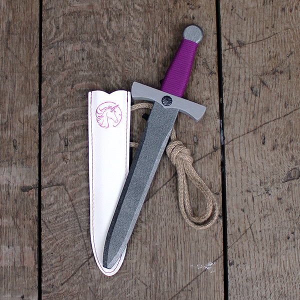 Silver painted wooden dagger with purple wrapped handle and white pleather sheath printed with purple unicorn branding