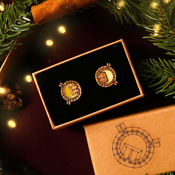 Earrings in a box with Christmas decorations around