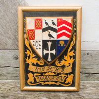 Wooden frame with a family crest on a wooden background
