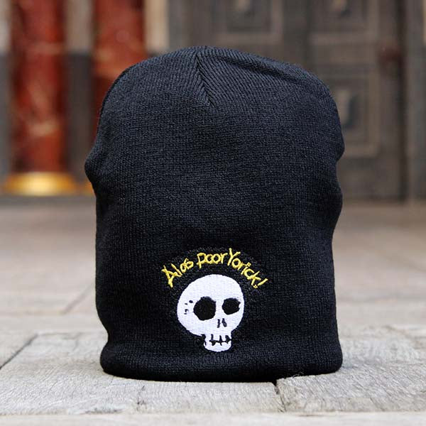 Black knit beanie with embroidered skull with graphic gold text above