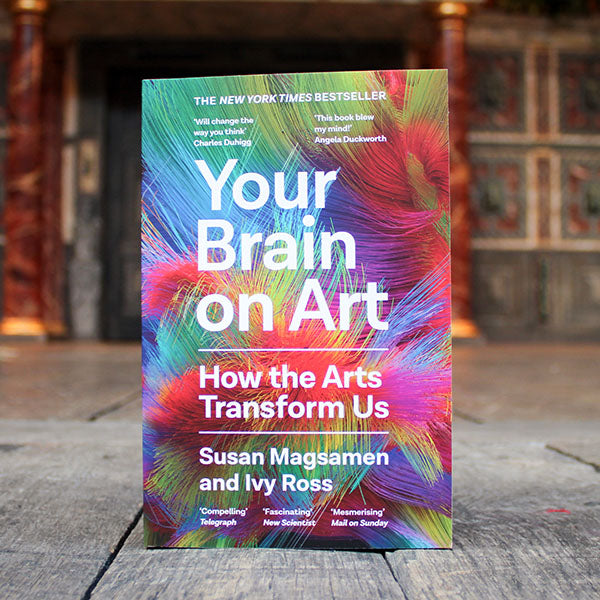 book with a colourful cover titles 'Your Brain on Art' on a wooden surface
