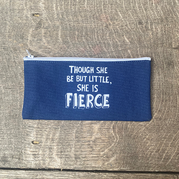 A mid-blue cotton pencil case with a white zip. The pencil case is printed on both sides with a quote from Shakespeare play, A Midsummer Night's Dream (though she is but little, she is fierce) in white hand-drawn capital letters.