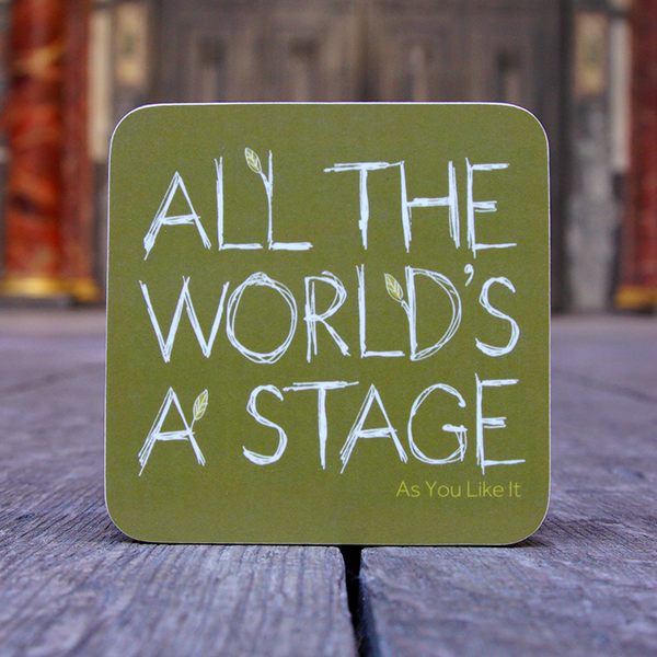 Khaki green square coaster made of melamine. The coaster has a quote from Shakespeare play, As You Like It (All the world's a stage) printed in large white capital letters. The lettering is hand-drawn ans made to look as though it is made out of twigs. Several of the letters have little leaves 'growing' out of them. The name of the play is printed in the bottom right-hand corner in lime green