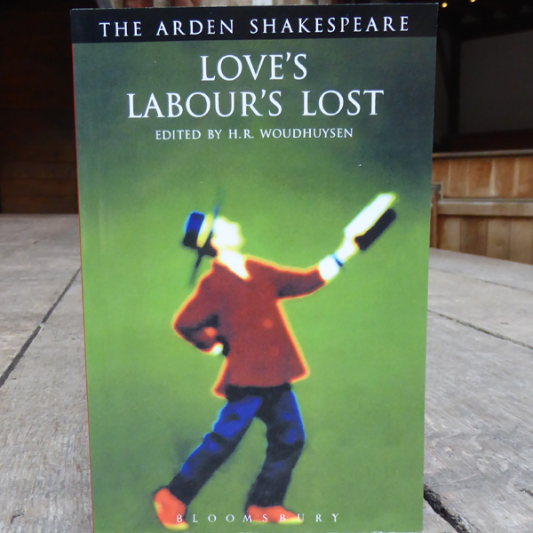 Green paperback book with distorted figure wearing blue trousers, brown top and blue hat