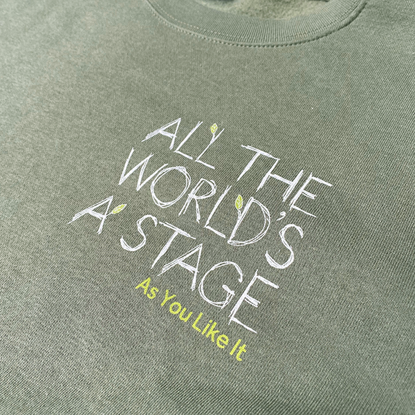 
                      
                        Sage green cotton sweatshirt with 'All The World's a Stage' quote on left breast.
                      
                    