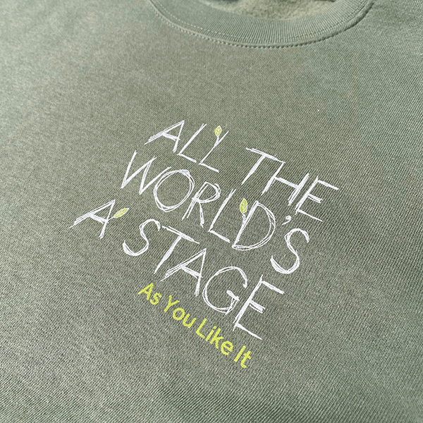 
                  
                    Sage green cotton sweatshirt with 'All The World's a Stage' quote on left breast.
                  
                