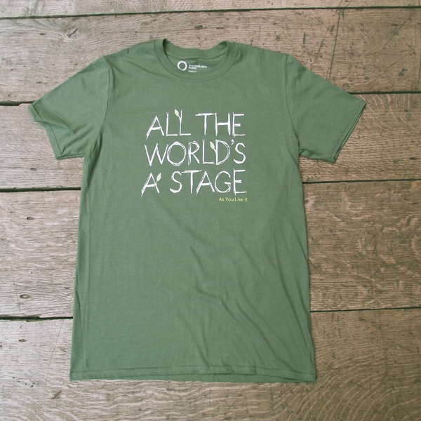 Sage green t-shirt with a round neckline. The t-shirt has a quote from Shakespeare play, As You Like It (all the world's a stage) printed in white centrally on the chest. The lettering is hand-drawn in a scribbled style to represent woodgrain and several of the lettering have lime green leaves growing out of them. The title of the play is printed in lime green under the quote.