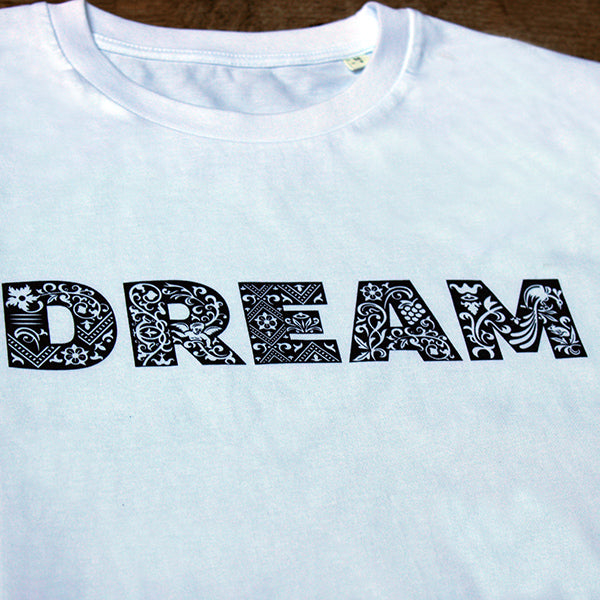 
                  
                    White unisex tshirt with navy blue graphic text across the chest depicting DREAM
                  
                
