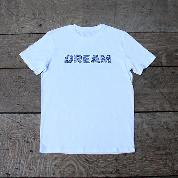 White unisex tshirt with navy blue graphic text across the chest depicting DREAM