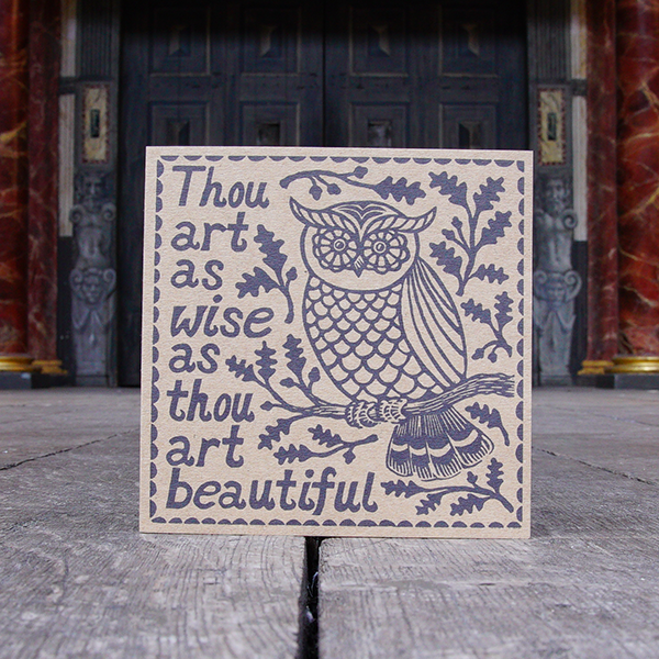 Greetings card made of kraft card with a lino-print of an owl sitting on an oak tree branch on the right hand side. On the left hand side is a quote from Shakespeare play, A Midsummer Night's Dream (Thou are as wise as thou art beautiful). The print is in black and is surrounded by a scalloped border.