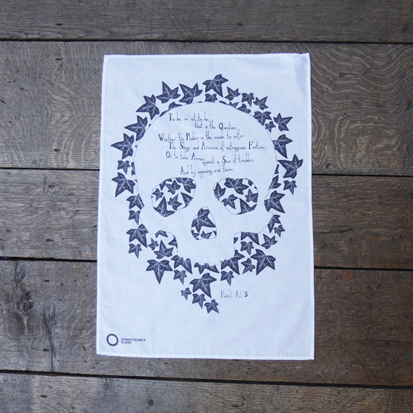 White cotton tea towel printed in grey with ivy leaves in skull shape with Hamlet's to be or not to be soliloquy 