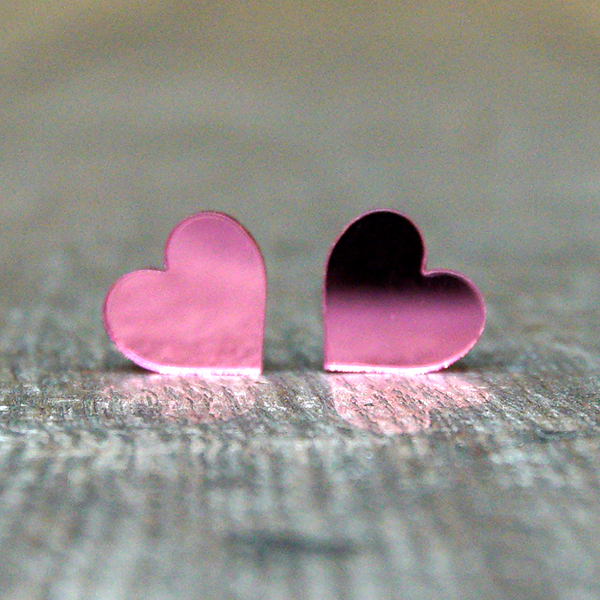 
                  
                    Heart shaped stud earrings made from light pink, mirrored acrylic.
                  
                