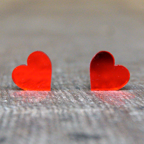 
                  
                    Heart shaped stud earrings made from bright red, mirrored acrylic.
                  
                