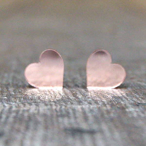 
                  
                    Heart shaped stud earrings made from rose gold coloured, mirrored acrylic.
                  
                