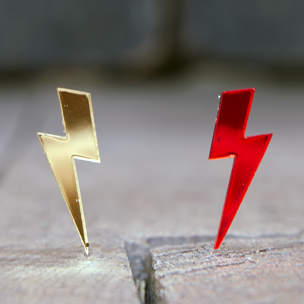 Acrylic earrings in the shape of lightning bolts. Red or gold mirror effect.