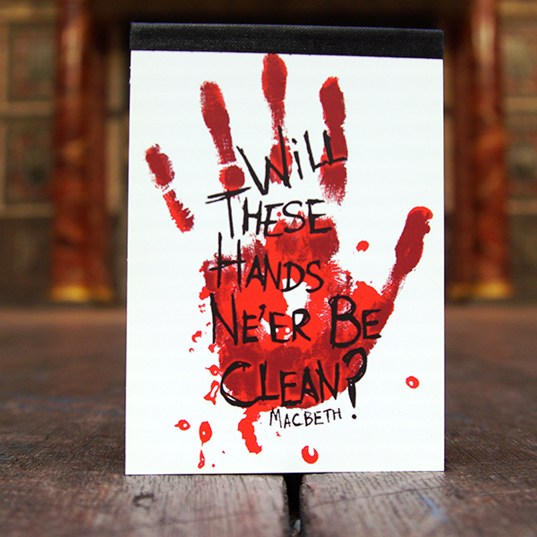 White pocket sized notepad with a red handprint on the cover. Over the handprint is a quote from Shakespeare play, Macbeth (Will these hands ne'er be clean?) printed in black in hand-drawn letters.